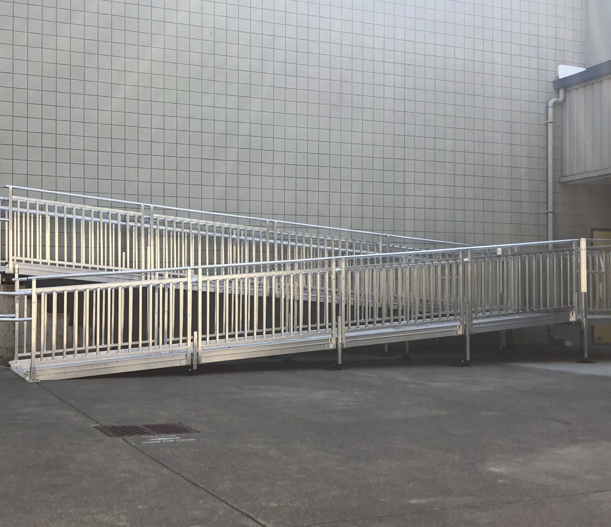 PATHWAY HD commercial aluminum ramp with guardrails running along a building entrance